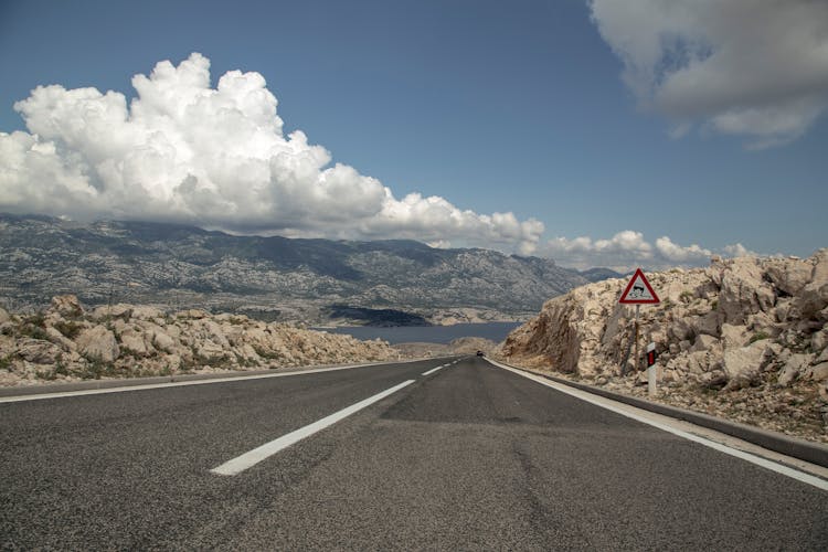 Wide Asphalt Road Through Mountainous Terrain