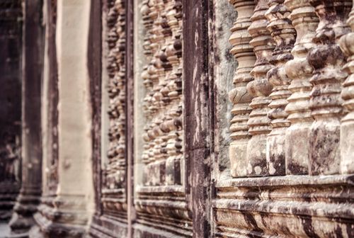 Free Facade of weathered building with stone columns on dirty walls in summer city Stock Photo