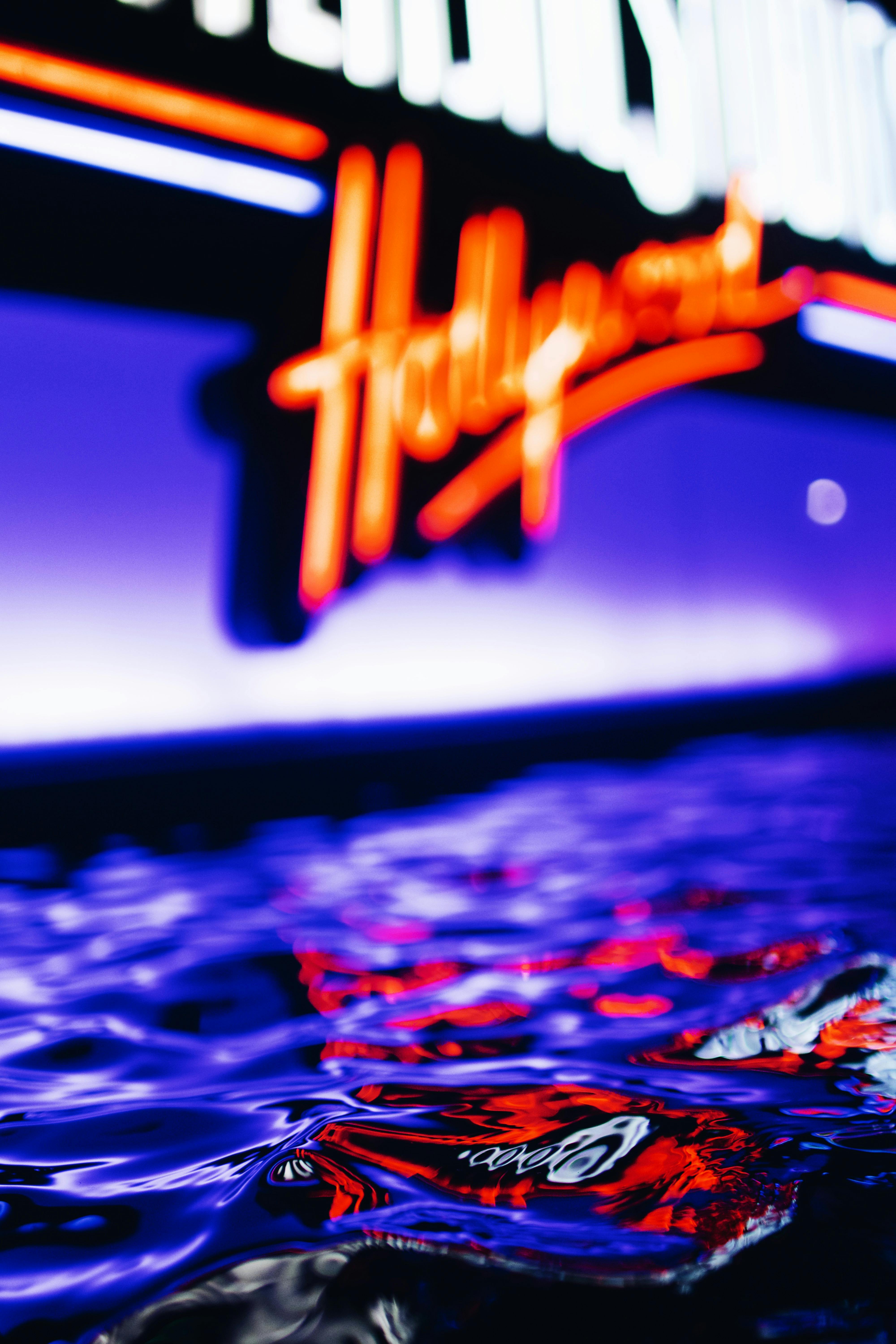 water splashing near illuminated sign