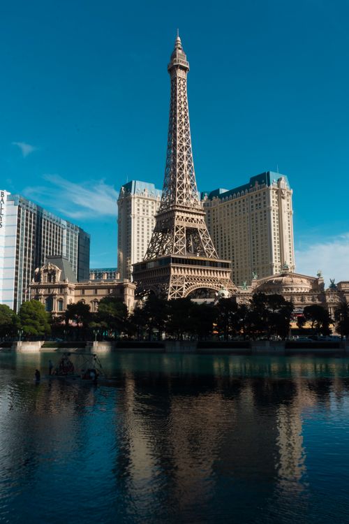 Free Eiffel Tower replica in Las Vegas with clear sky and water reflection, ideal for travel themes. Stock Photo