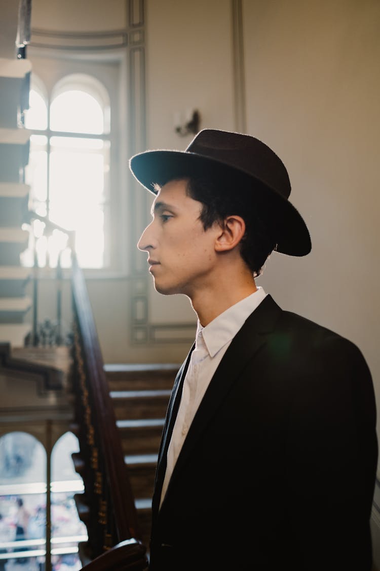 Jewish Man In Hat Posing Near Stairs In Old Building