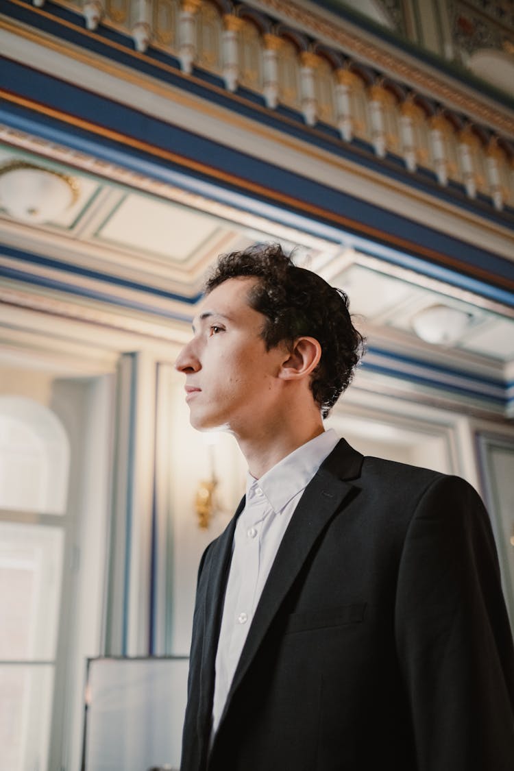 Elegant Man In A Suit Standing In A Palace