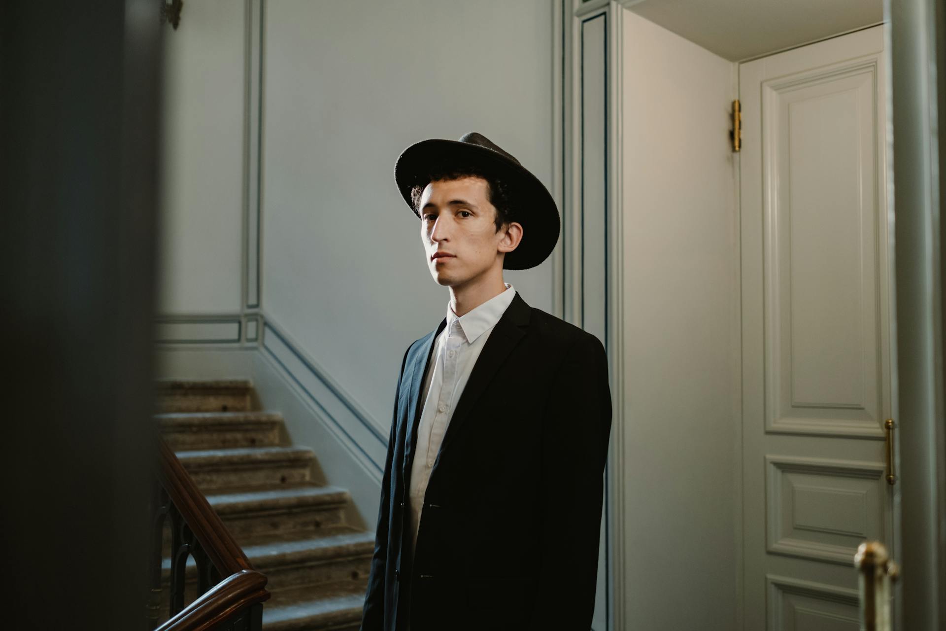 Young Man in Traditional Jewish Attire on the Staircase