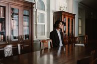 Man in Black Blazer Sitting on Chair