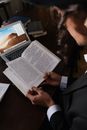 Man in Black Suit Holding White Printer Paper
