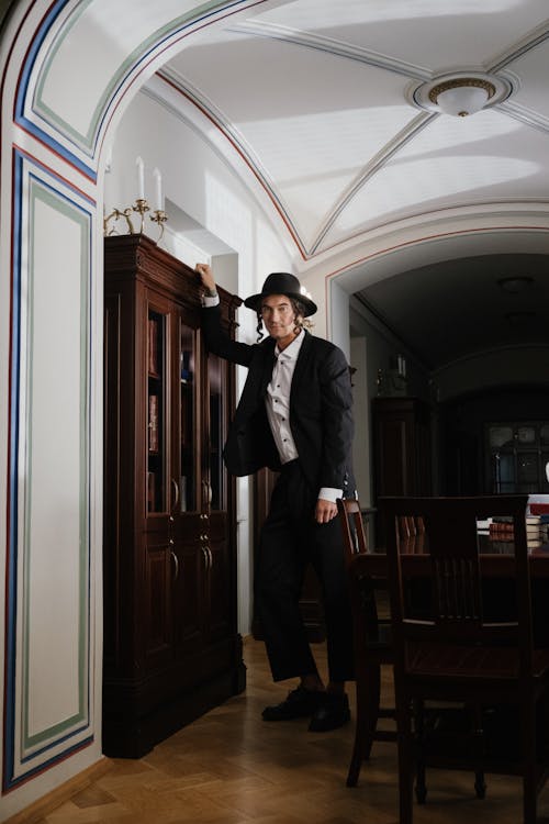 A Man in Black Suit Wearing Black Hat · Free Stock Photo