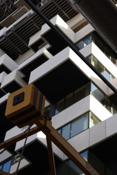 Close-up of a contemporary high-rise building showcasing geometric balconies and glass facades.