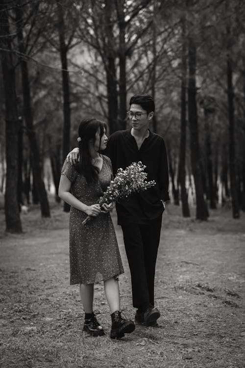 Asian couple walking in park