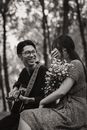 Asian couple with guitar in park