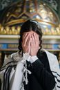 Woman in Black and White Coat Covering Her Face
