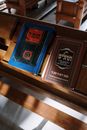 Black and Brown Book on Brown Wooden Shelf