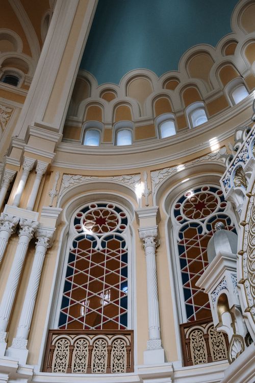Free Explore the ornate architecture and colorful stained glass windows of this historic cathedral interior. Stock Photo