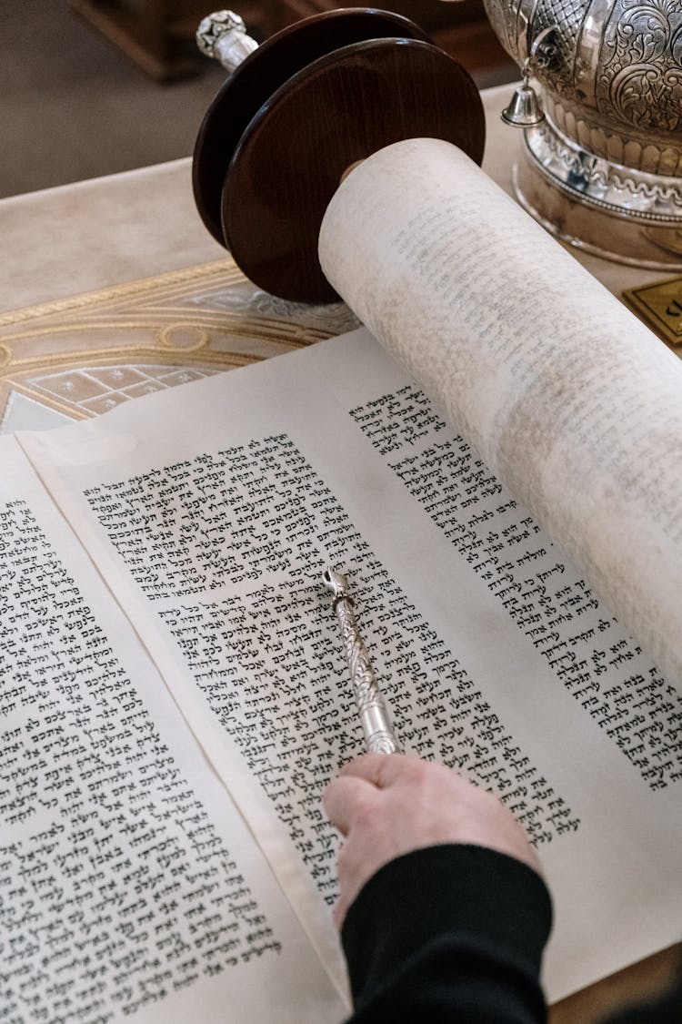 A Person Reading A Scroll