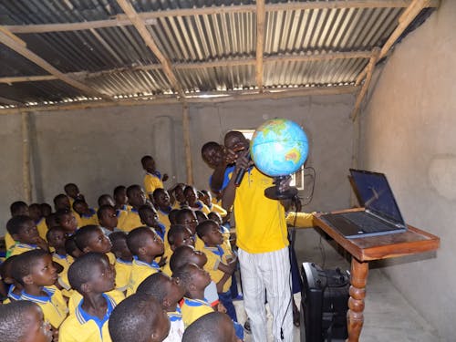 A Teacher Showing a Globe to the Students