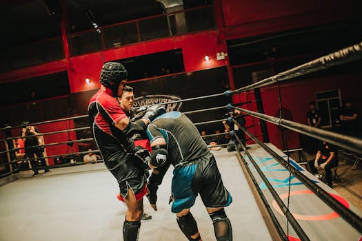 Two athletes compete in a fierce boxing match inside a well-lit indoor arena.