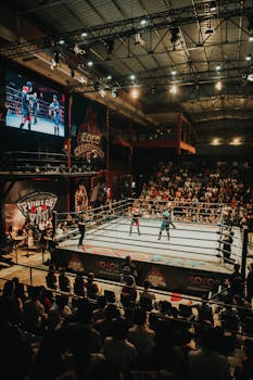 High-energy boxing match captured in a bustling indoor stadium with a full audience.