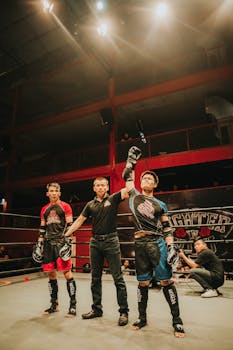 Mixed martial arts match with the winner announced in a boxing ring under bright lights.