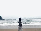 A Woman Walking on the Beach