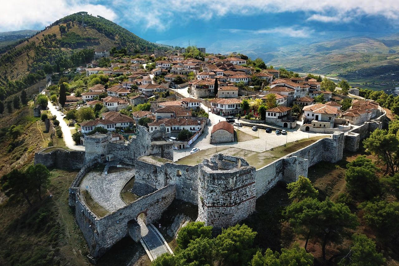 A breathtaking aerial shot of Berat Castle showcasing historic architecture and landscape.