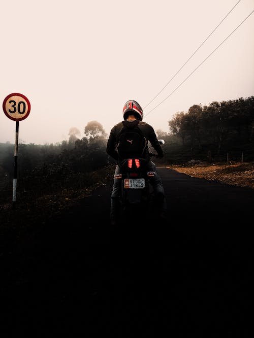 Back View of a Man Riding a Motorcycle