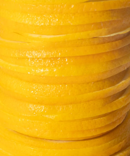 Full frame background of pile of sliced pieces of fresh juicy orange in closeup