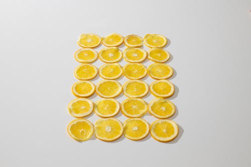 Free From above composition of fresh juicy oranges cut in slices and laid on white background Stock Photo