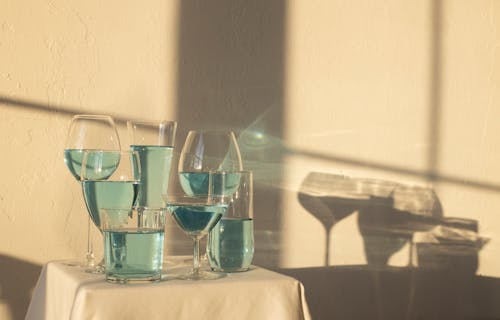 Blue alcoholic drink in glasses on table