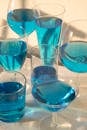 Glasses with blue alcoholic cocktails