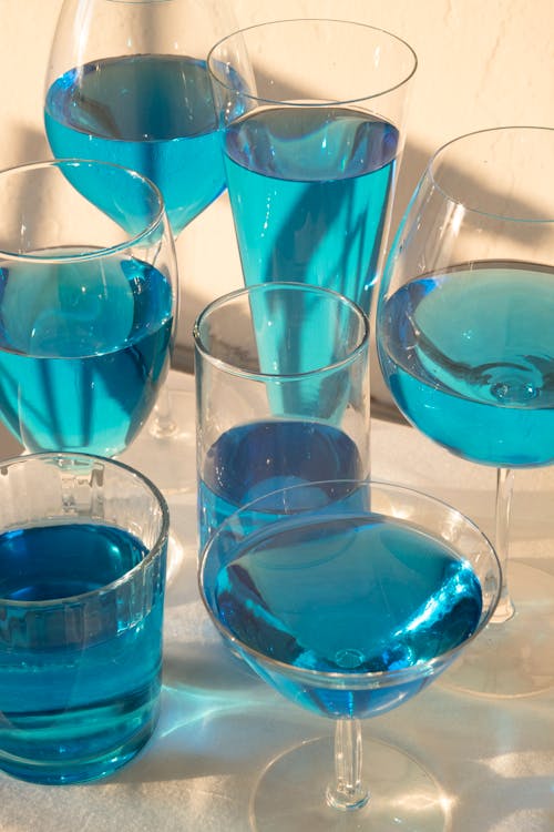 Glasses with blue alcoholic cocktails