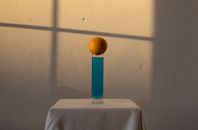 Long glass with blue drink and orange above