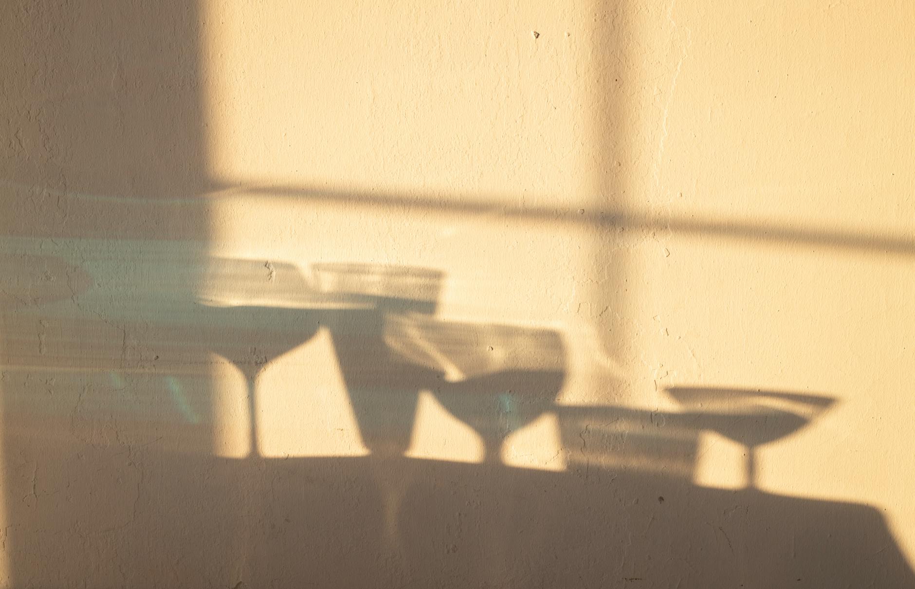 Shadows of different crystal glasses filled with drinks