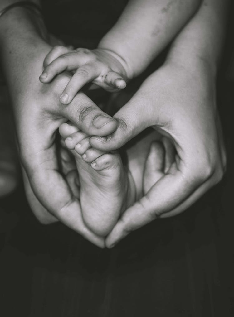 Holding The Feet Of A Baby