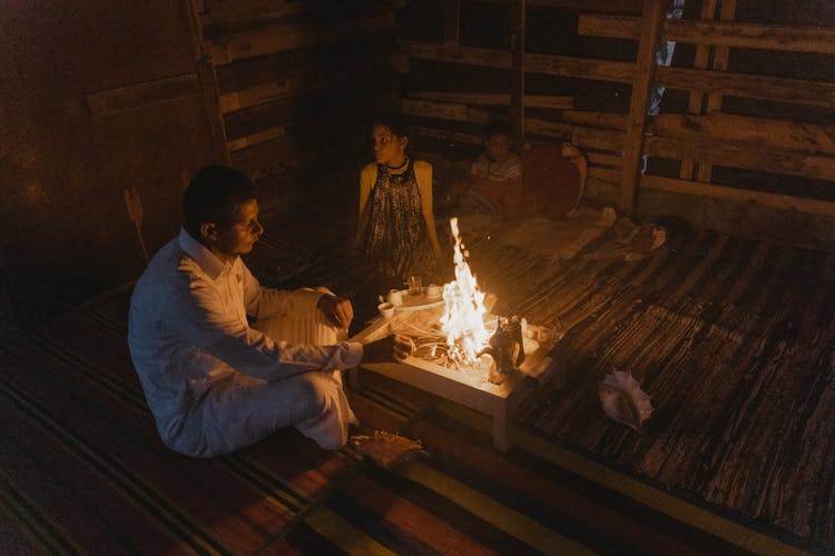 A Man And A Woman Cooking At The Table