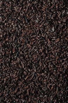 Detailed vertical shot showcasing organic cacao nibs texture, perfect for food photography projects.