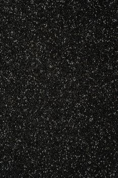 Close-up of textured black chia seeds, perfect for healthy diet concepts.
