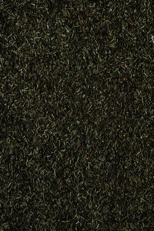 Free Detailed close-up of dark, dried herbal leaves creating a textured background. Stock Photo