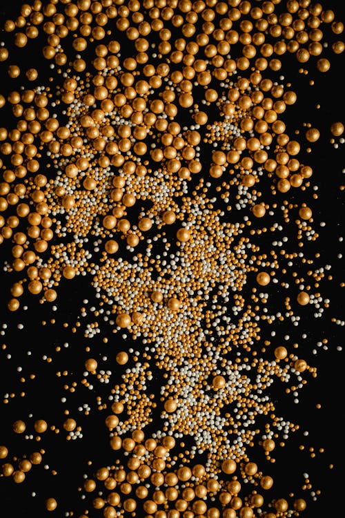 Top View of Golden and White Pearls on a Black Surface