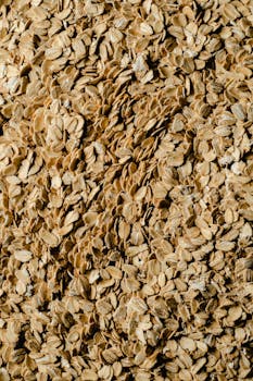 A detailed close-up view of textured rolled oats, ideal for food and health themes.