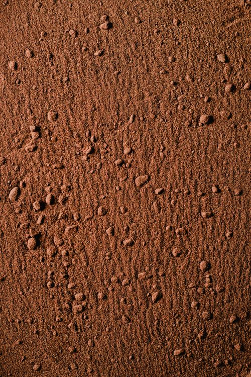 Free Detailed close-up of rough brown soil texture showcasing natural patterns. Stock Photo
