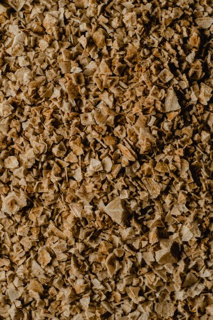 Detailed close-up of brown salt flakes showcasing texture and natural pattern.