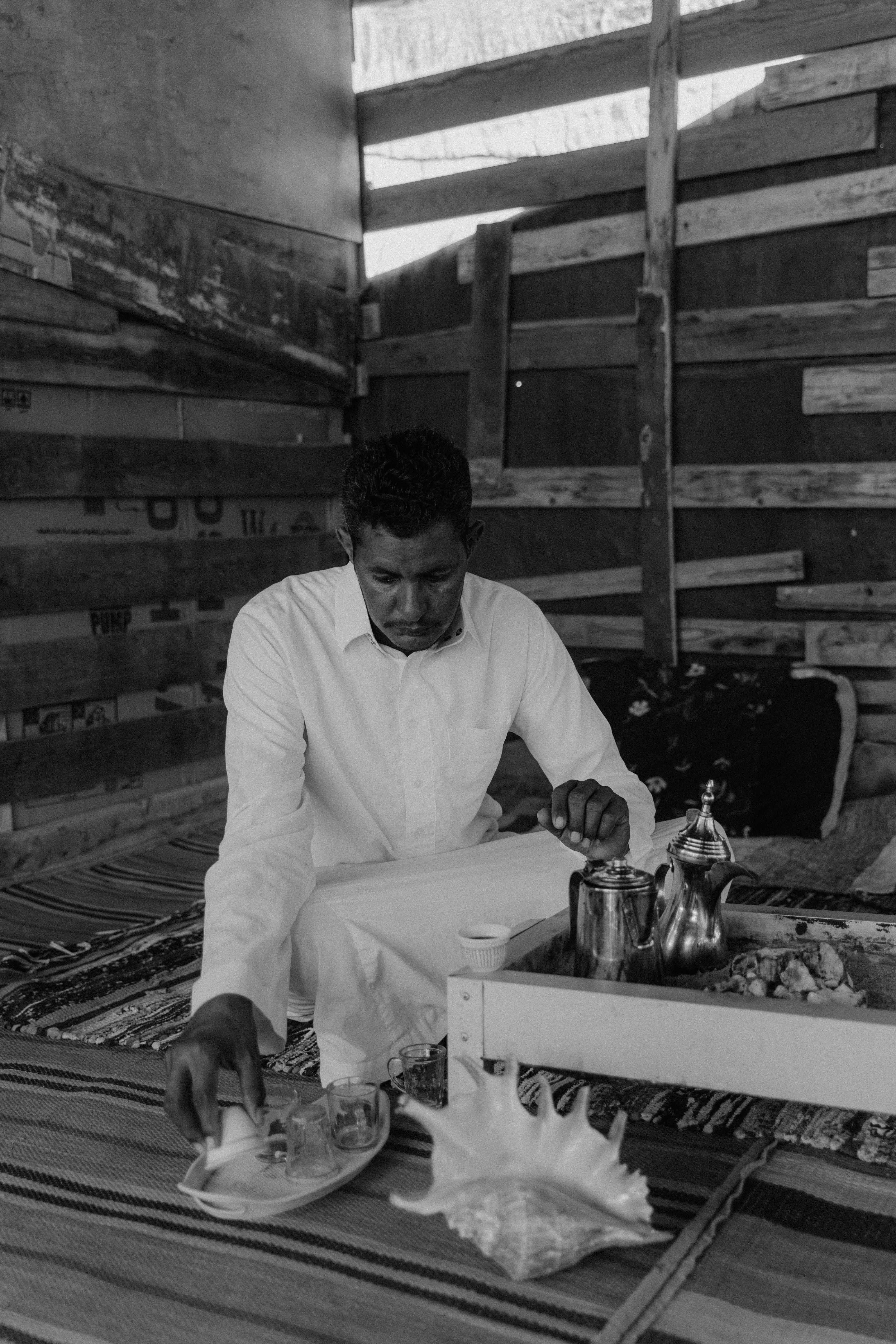 A Grayscale of a Man Preparing Tea · Free Stock Photo