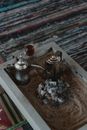 Stainless Teapots beside a Hot Charcoal