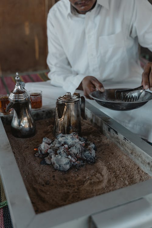 Man in White Dress Shirt Holding Stainless Steel Tray