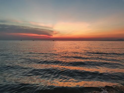 Free Beautiful sunset over the ocean in Chonburi, Thailand, capturing vibrant hues and serene waters. Stock Photo