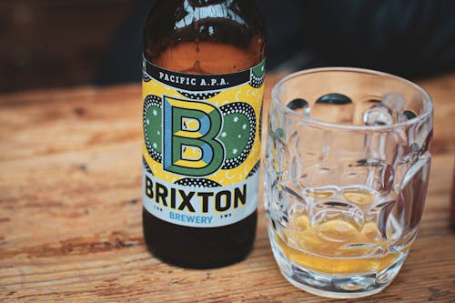 A Bottle of Brixton Beer Beside a Clear Drinking Glass