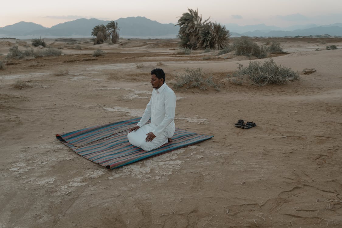 Photo Of Man Kneeling On Mat 