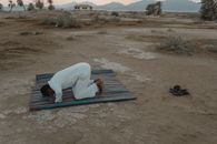 Photo Of Man Bowing On Mat During Dawn
