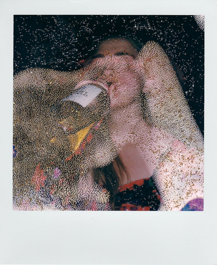 Polaroid Picture Of A Woman Drinking Wine From The Bottle 