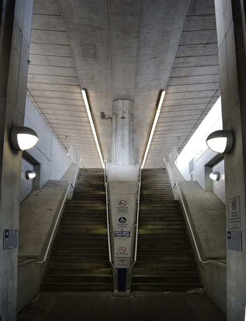 Free Symmetrical concrete staircase in a St. Louis subway station with neon lighting and clear signs. Stock Photo