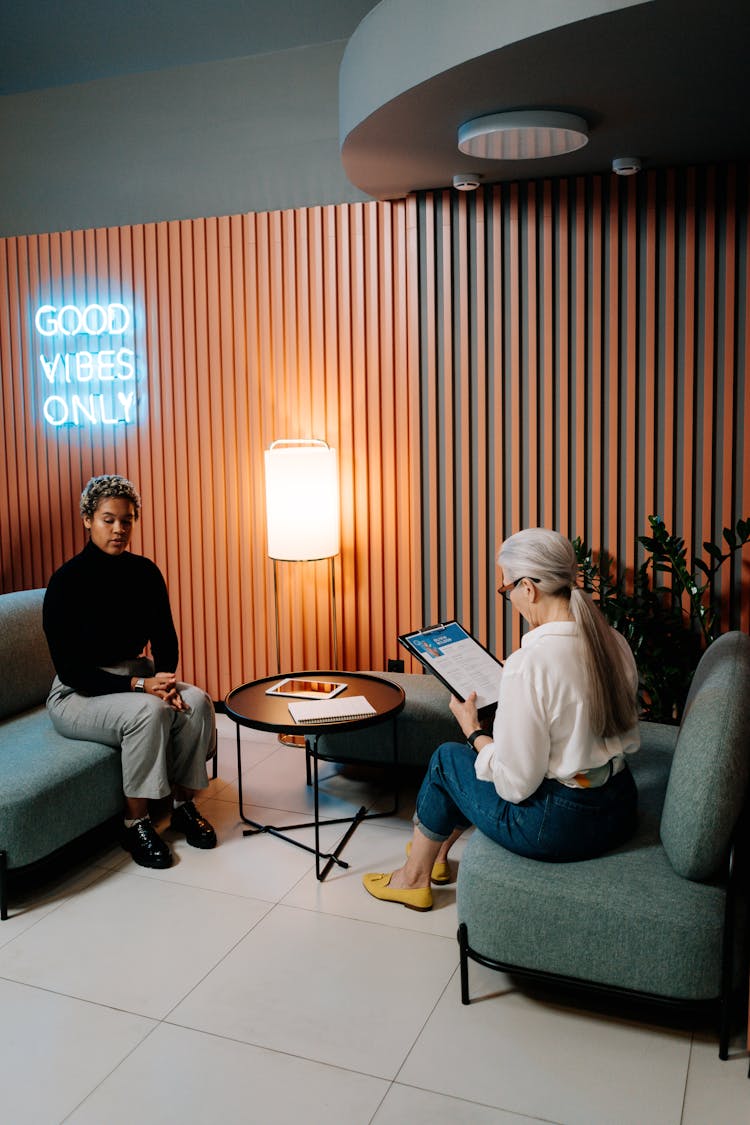 Woman In Black Long Sleeve Shirt Having A Job Interview